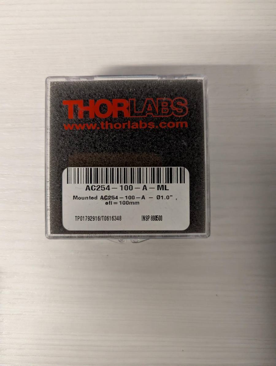 Thorlabs AC254-100-A-ML lens in its box